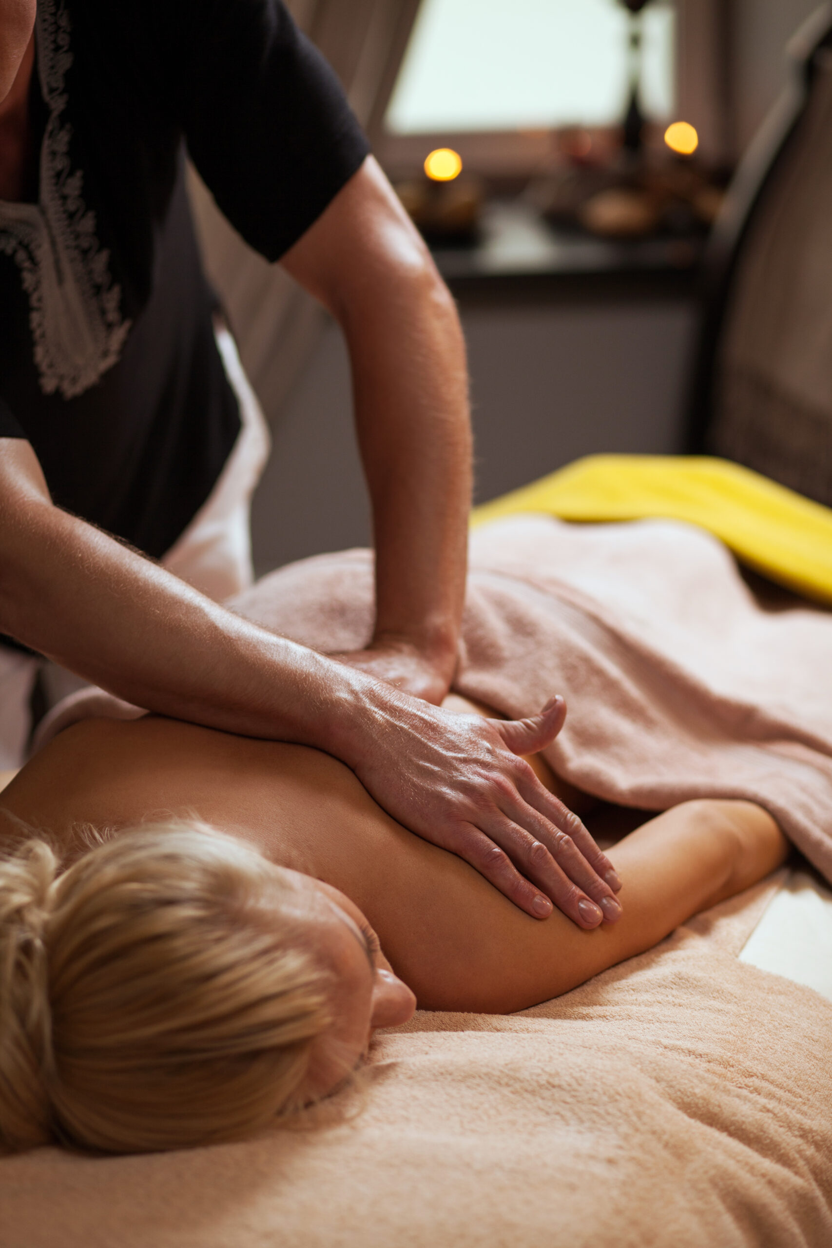 Young woman enjoys massage in a spa